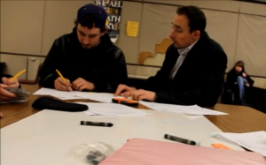 Math teacher Spencer Stiglets (right) helps a student after school about a math problem.
