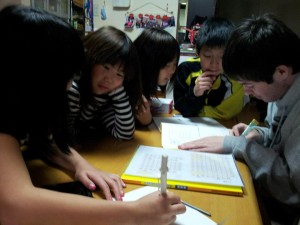 Cuplin gets some help from young new friends while working on his Japanese characters.