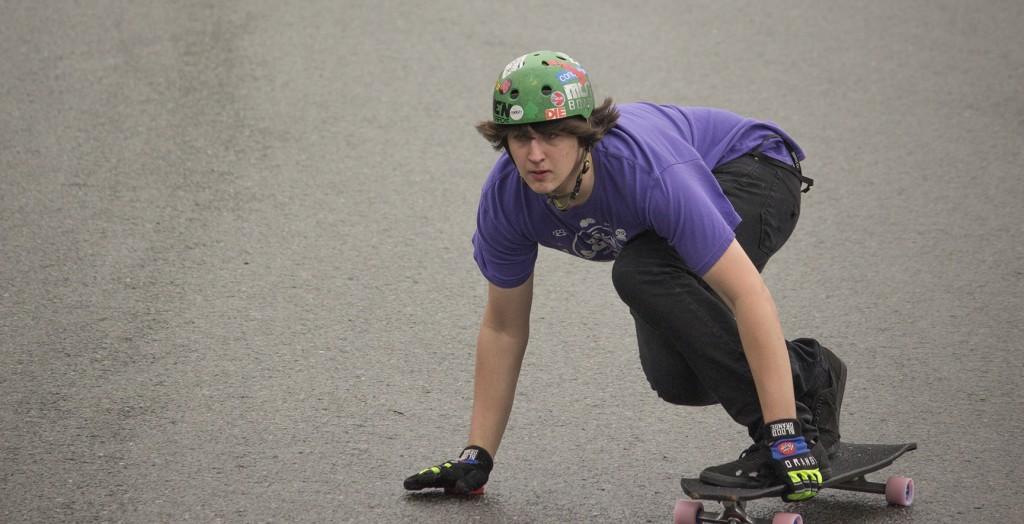 Sam Galus slides down a hill wearing his sponsored Blood Orange gloves