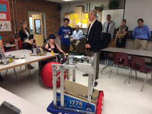 MTHS FIRST Robotics members show off their robots to Larsen.